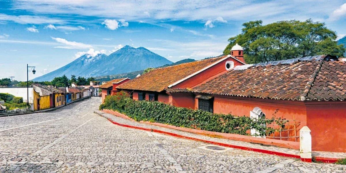 Colonial rooftops of Antigua Guatemala beneath the volcano