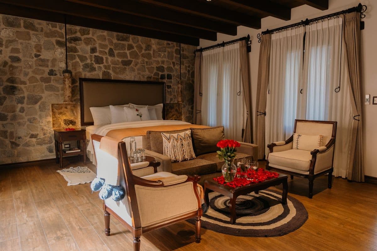 Guest room with red roses and rose petals arranged on the coffee table